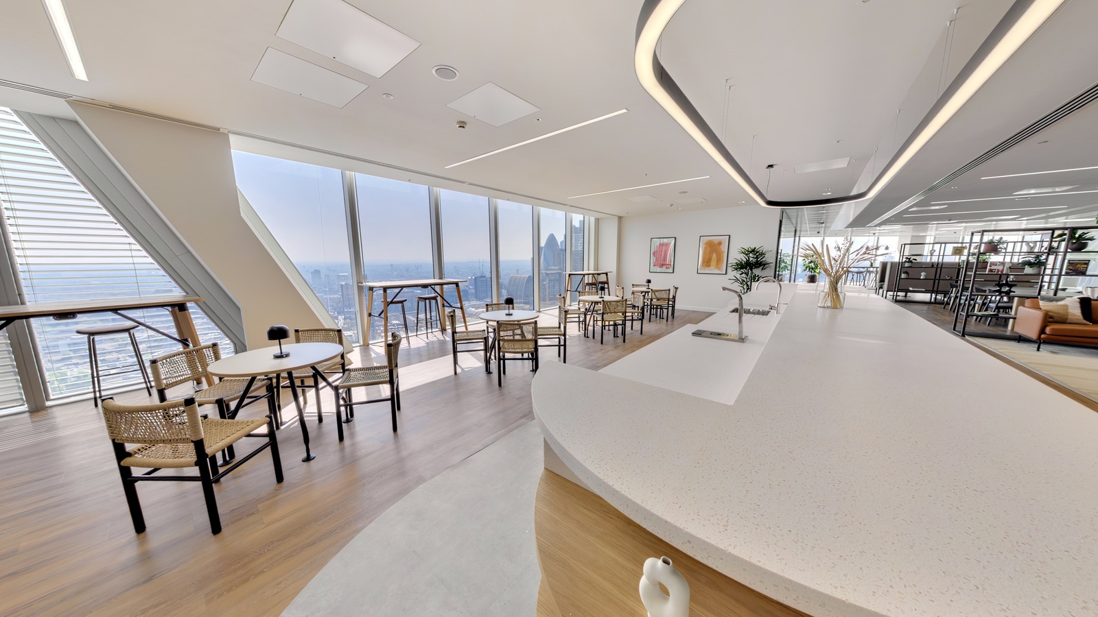 Bright London office breakout space with floor-to-ceiling City skyline views