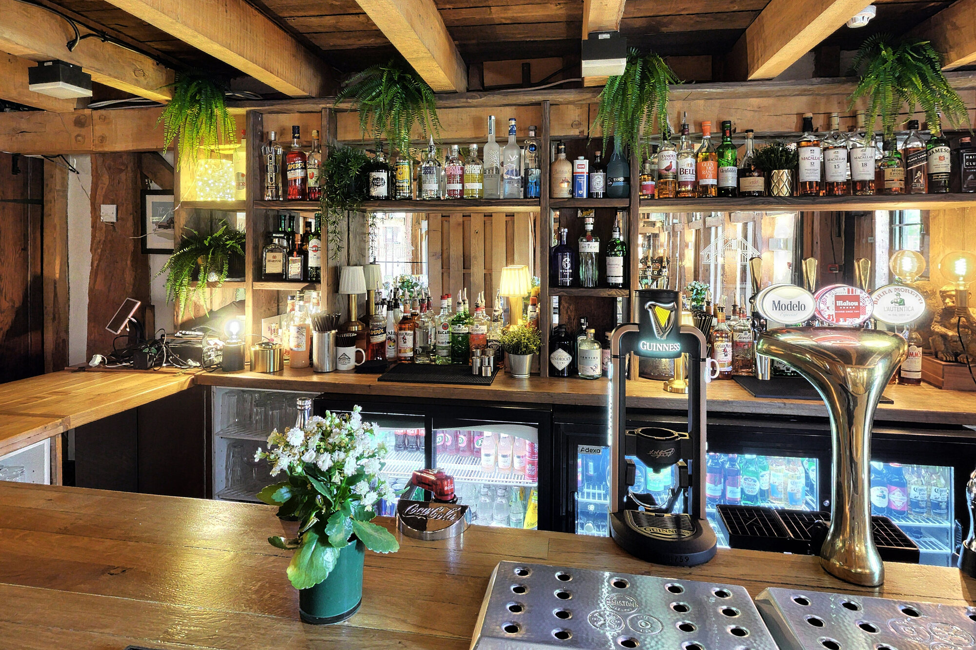 A stocked timber bar inside the barn venue, ready for an evening reception