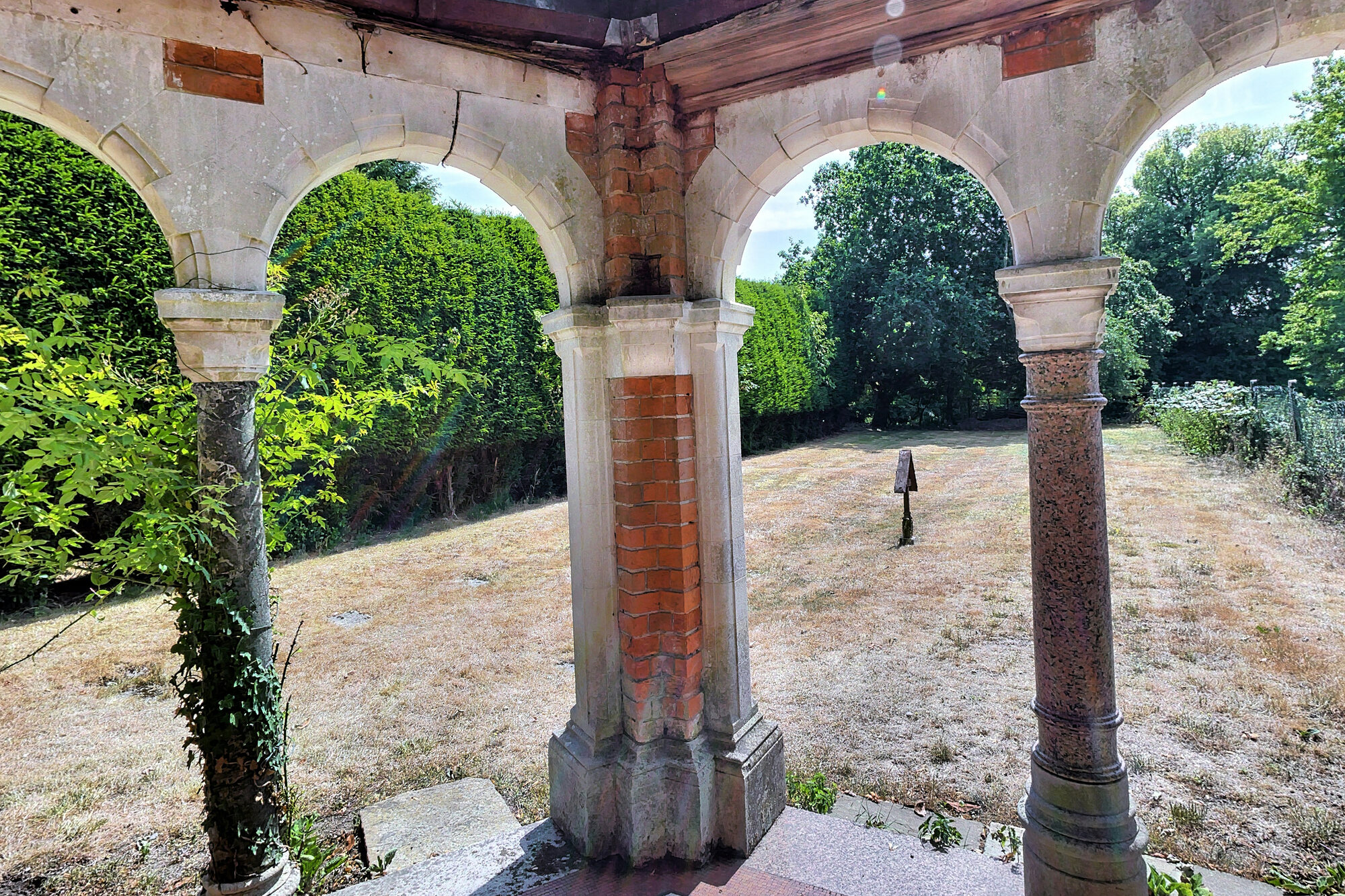 A red-brick arched garden chapel set in the grounds